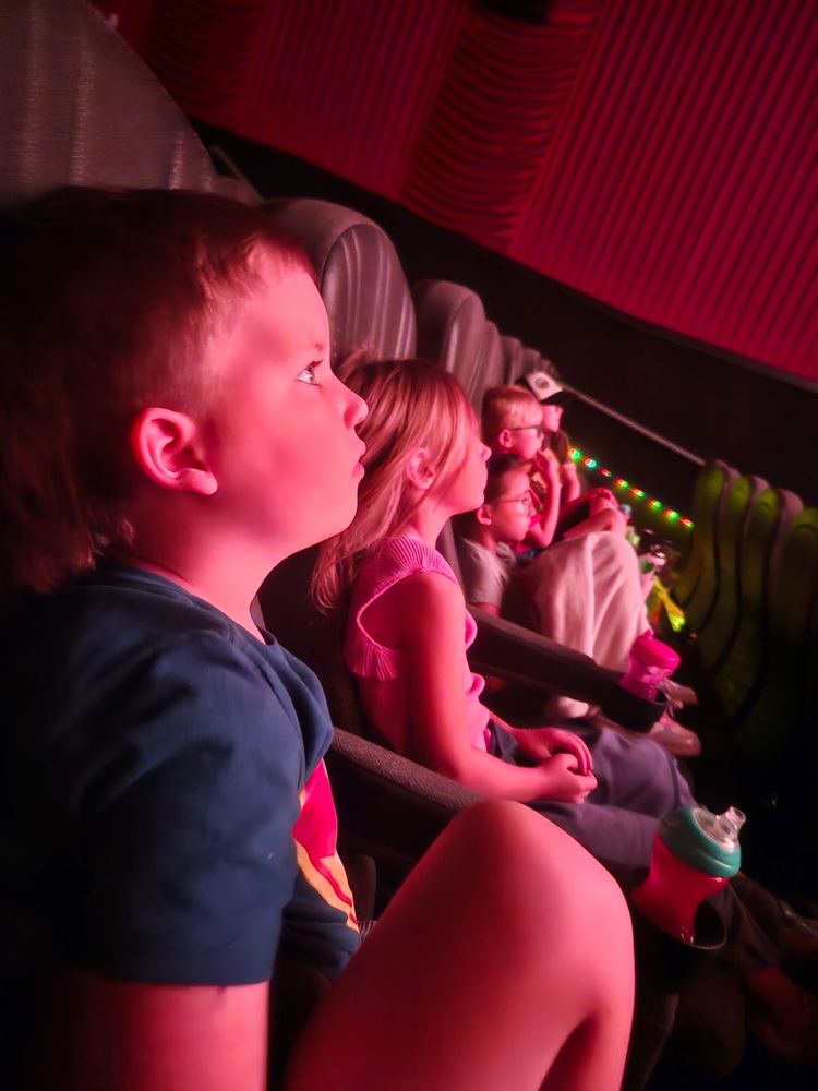 Children watching a movie on a field trip